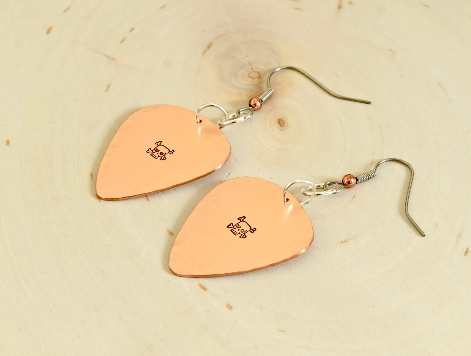 Skulls and crossbones on guitar pick earrings